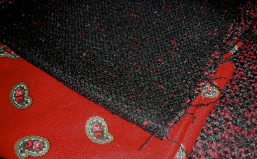 Fabric Black and red boucle that I found on sale at Hancock Fabrics in Madison, WI. This was probably a really poor choice—it unraveled instantaneously, was difficult to work with, and shed shreds all over my apartment. I decided to make the neck facings and finish the sleeves with a cotton paisley, because the boucle was so bulky.